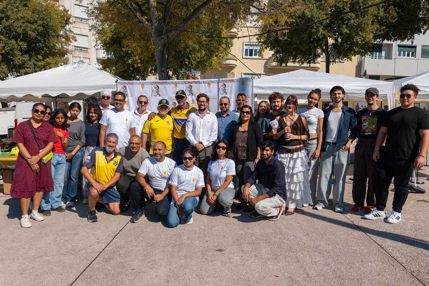 TLG Foundation team and partners posing together at Festival Gandhi 2026, Alameda Park, Lisbon