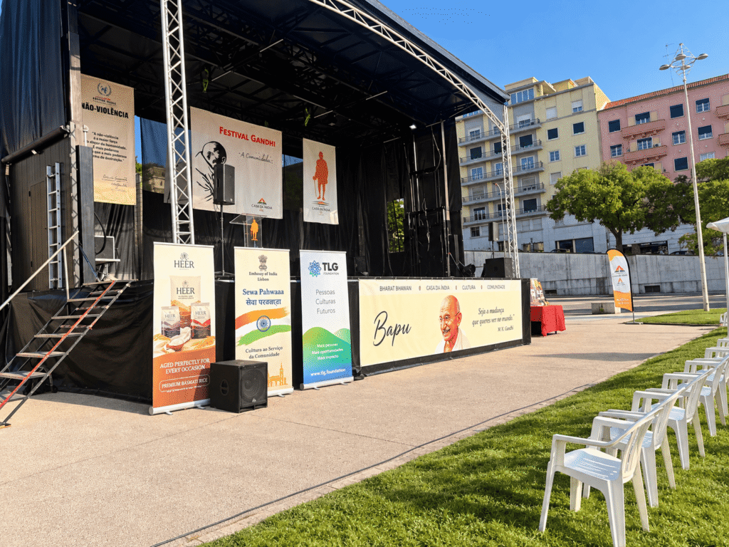 The Festival Gandhi 2026 main stage decorated with Casa da Índia and TLG Foundation banners, Alameda Park, Lisbon